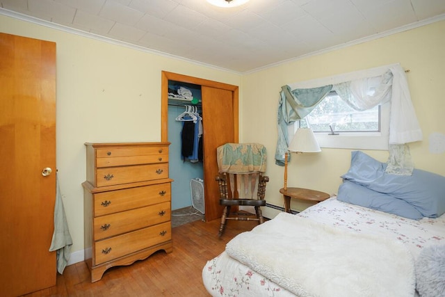 103 Mountain View Rd, Farmington, ME 04938 - bedroom featuring ornamental molding, a closet, and wood finished floors