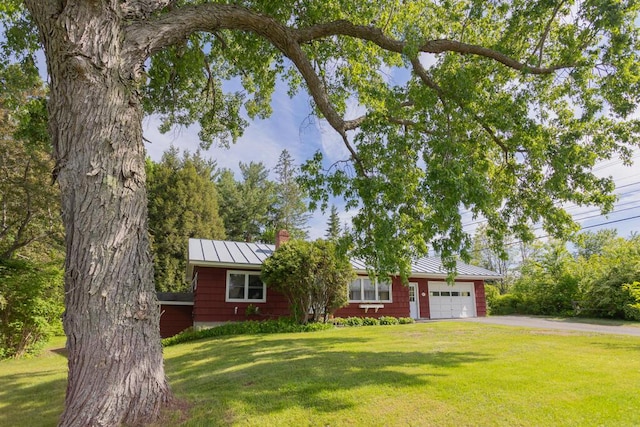 103 Mountain View Rd, Farmington, ME 04938 - single story home with a standing seam roof, a garage, a chimney, a front lawn, and a metal roof
