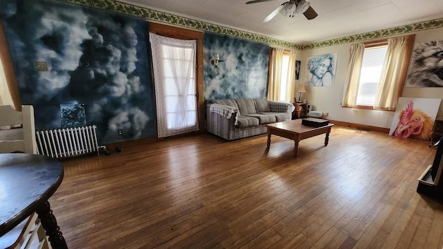 28 Eastland Ave, Millinocket, ME 04462 - living area featuring hardwood / wood-style floors, healthy amount of natural light, radiator, and ceiling fan