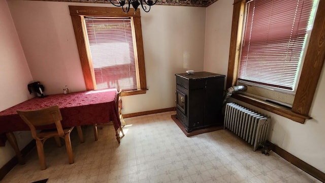 28 Eastland Ave, Millinocket, ME 04462 - dining room with radiator, light floors, a chandelier, and healthy amount of natural light