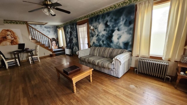28 Eastland Ave, Millinocket, ME 04462 - living area featuring radiator, hardwood / wood-style floors, stairs, and ceiling fan