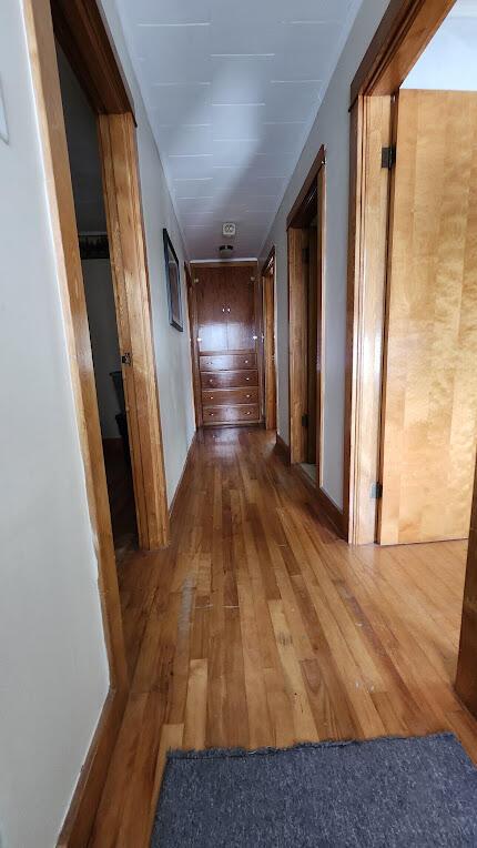 28 Eastland Ave, Millinocket, ME 04462 - hallway with hardwood / wood-style floors