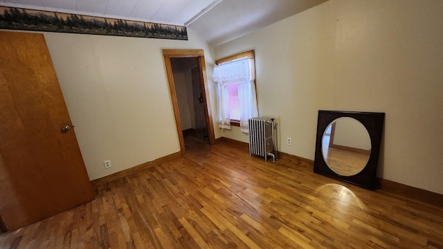 28 Eastland Ave, Millinocket, ME 04462 - spare room featuring radiator and wood finished floors