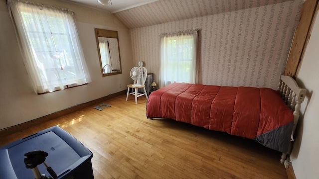 28 Eastland Ave, Millinocket, ME 04462 - bedroom with wood finished floors, lofted ceiling, and wallpapered walls