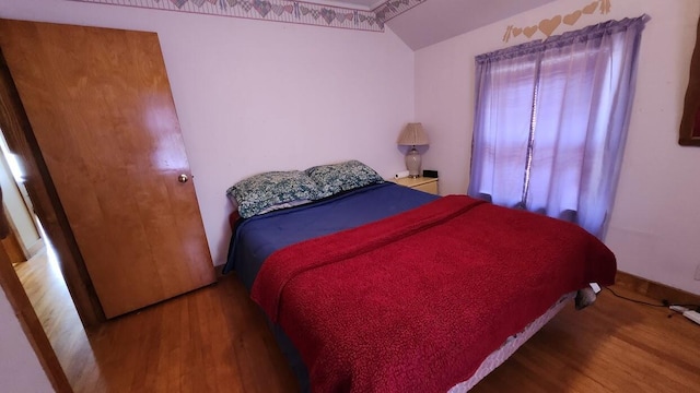 28 Eastland Ave, Millinocket, ME 04462 - bedroom with wood finished floors and lofted ceiling
