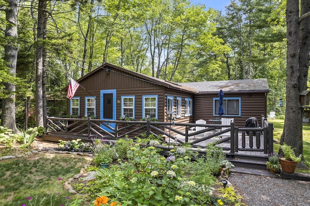 94 Crest Ave, Boothbay Harbor, ME 04538 - view of front of house featuring log veneer siding, a deck, and a shingled roof