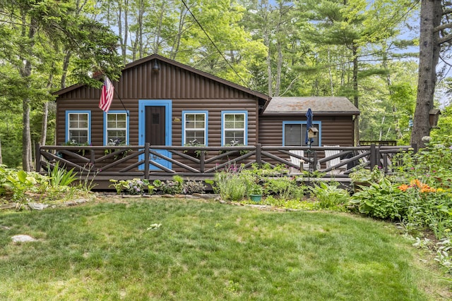 94 Crest Ave, Boothbay Harbor, ME 04538 - view of front facade featuring a front lawn, faux log siding, a deck, and board and batten siding