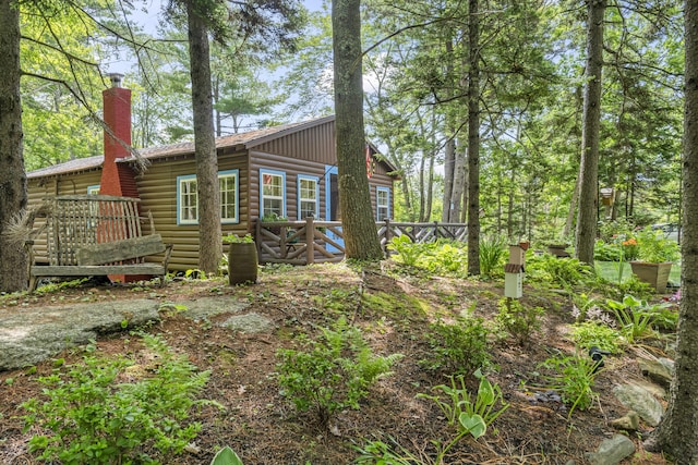 94 Crest Ave, Boothbay Harbor, ME 04538 - view of home's exterior with a deck, a chimney, and log veneer siding