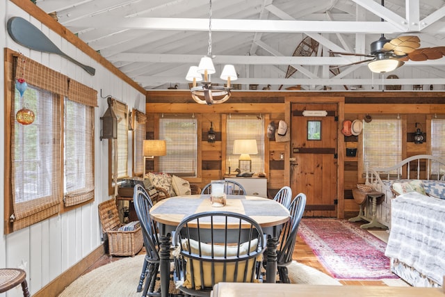 94 Crest Ave, Boothbay Harbor, ME 04538 - dining space with wooden walls, a chandelier, plenty of natural light, wood finished floors, and beam ceiling
