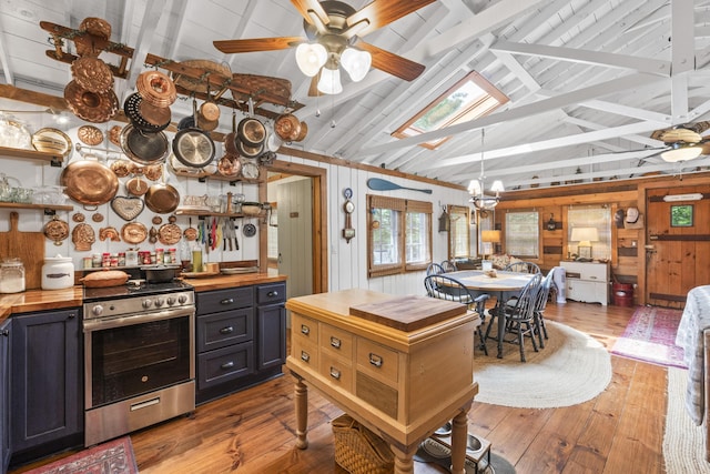 94 Crest Ave, Boothbay Harbor, ME 04538 - kitchen featuring butcher block countertops, stainless steel range, wood walls, hardwood / wood-style floors, and a chandelier