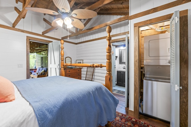 94 Crest Ave, Boothbay Harbor, ME 04538 - bedroom featuring stacked washer / drying machine, wood finished floors, ensuite bath, wood walls, and a ceiling fan