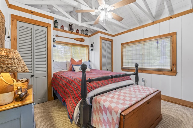 94 Crest Ave, Boothbay Harbor, ME 04538 - bedroom featuring carpet, multiple closets, a ceiling fan, and wood walls