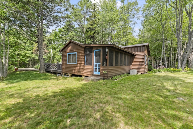 94 Crest Ave, Boothbay Harbor, ME 04538 - view of front facade featuring log veneer siding, a front yard, and a wooden deck