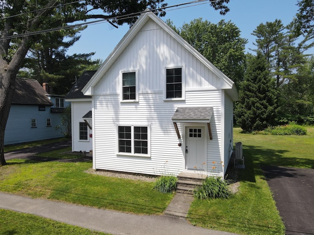 42 Hillside Rd, Orono, ME 04473 - view of front of property featuring board and batten siding, a front lawn, and a shingled roof