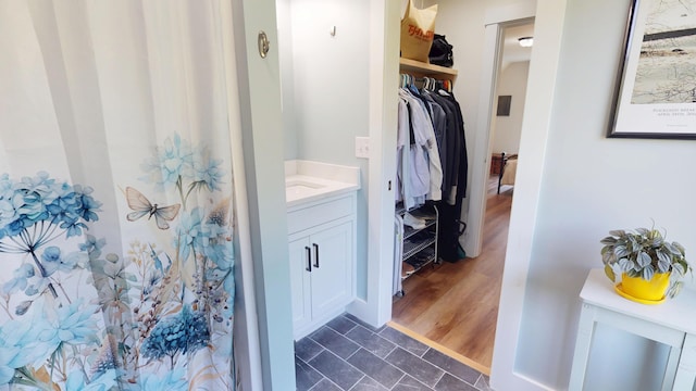 42 Hillside Rd, Orono, ME 04473 - bathroom featuring vanity, a shower with curtain, and a walk in closet