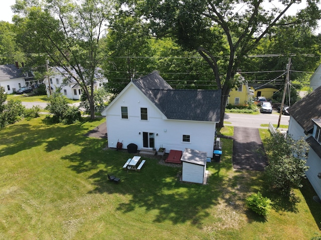 42 Hillside Rd, Orono, ME 04473 - back of property with roof with shingles, a yard, and entry steps