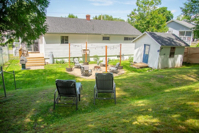 133 Ohio St, Millinocket, ME 04462 - view of yard featuring a fire pit, a shed, and a patio