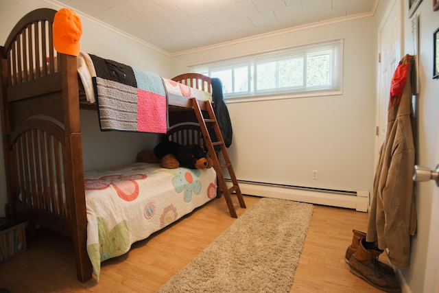 133 Ohio St, Millinocket, ME 04462 - bedroom featuring a baseboard heating unit, crown molding, and wood finished floors