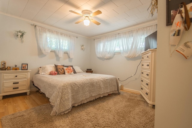 133 Ohio St, Millinocket, ME 04462 - bedroom featuring multiple windows, ornamental molding, light wood-style flooring, and ceiling fan