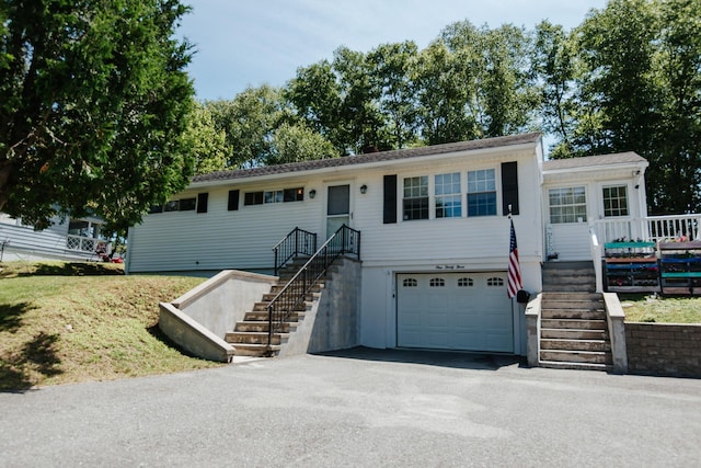 133 Ohio St, Millinocket, ME 04462 - ranch-style home with an attached garage, stairway, and asphalt driveway