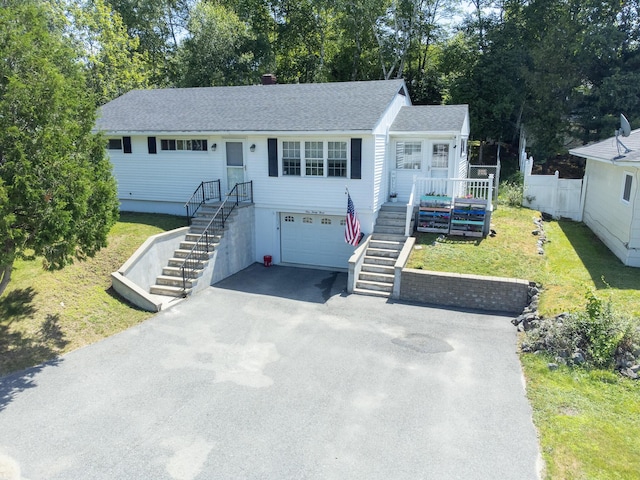133 Ohio St, Millinocket, ME 04462 - view of front of property with stairway, driveway, a garage, a shingled roof, and view of wooded area