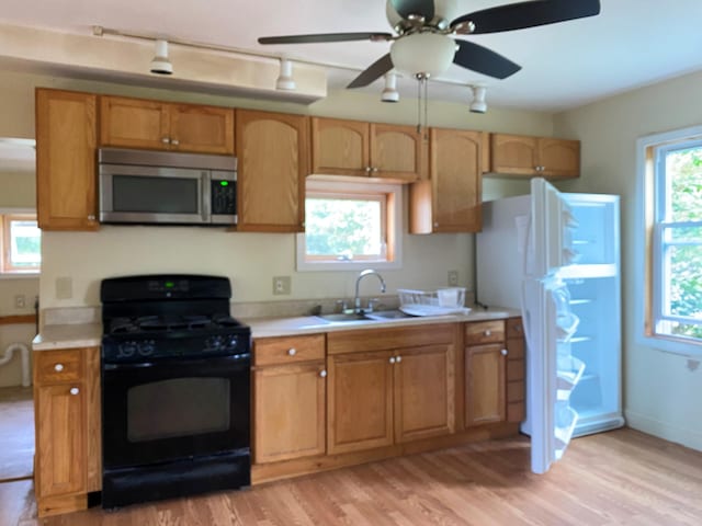 65 Quarry Rd, Sullivan, ME 04664 - kitchen with stainless steel microwave, black gas stove, light countertops, and light wood finished floors