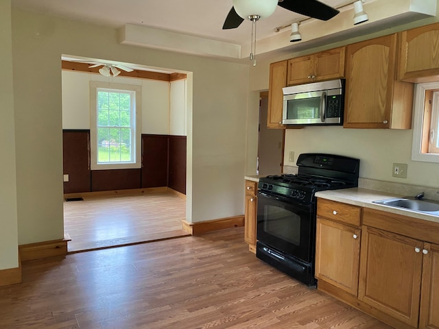 65 Quarry Rd, Sullivan, ME 04664 - kitchen featuring stainless steel microwave, gas stove, ceiling fan, and light wood finished floors
