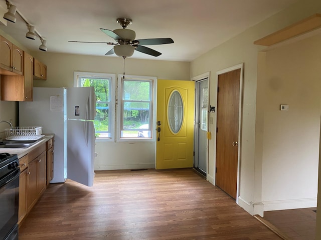 65 Quarry Rd, Sullivan, ME 04664 - kitchen with wood finished floors, black range, a ceiling fan, and freestanding refrigerator