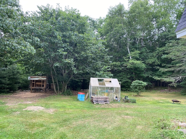 65 Quarry Rd, Sullivan, ME 04664 - view of green lawn featuring a greenhouse and an outbuilding