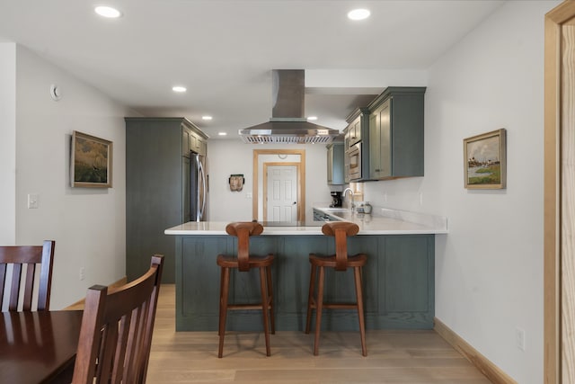 86 City Point Rd, Vinalhaven, ME 04863 - kitchen with range hood, stainless steel appliances, recessed lighting, light wood-type flooring, and light countertops