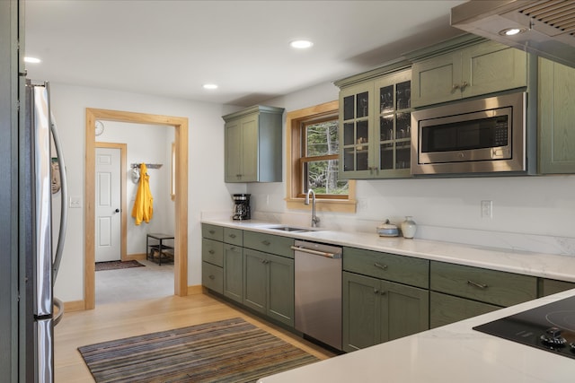 86 City Point Rd, Vinalhaven, ME 04863 - kitchen with stainless steel appliances, green cabinetry, recessed lighting, glass insert cabinets, and light wood-style flooring