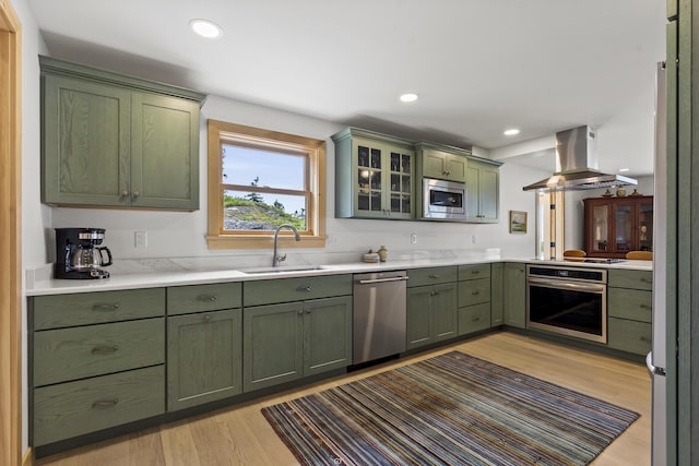 86 City Point Rd, Vinalhaven, ME 04863 - kitchen with green cabinets, stainless steel appliances, island range hood, light wood-type flooring, and light countertops