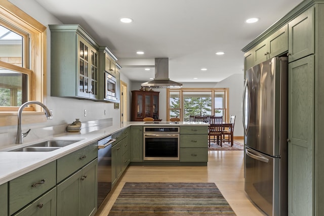 86 City Point Rd, Vinalhaven, ME 04863 - kitchen with green cabinetry, stainless steel appliances, island range hood, a peninsula, and recessed lighting