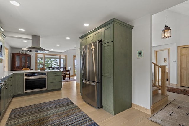 86 City Point Rd, Vinalhaven, ME 04863 - kitchen featuring green cabinetry, appliances with stainless steel finishes, exhaust hood, light wood finished floors, and recessed lighting