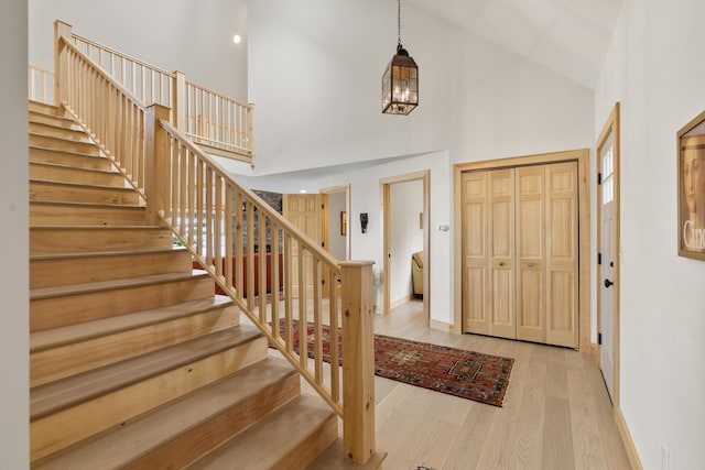 86 City Point Rd, Vinalhaven, ME 04863 - foyer entrance featuring high vaulted ceiling, stairs, and wood finished floors