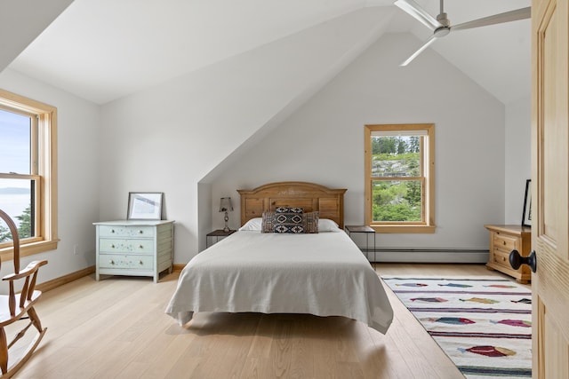 86 City Point Rd, Vinalhaven, ME 04863 - bedroom featuring baseboard heating, light wood-style flooring, and vaulted ceiling