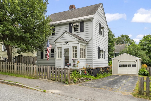 22 Cobb Rd, Bath, ME 04530 - view of front of house with an outbuilding, a chimney, asphalt driveway, a shingled roof, and a garage