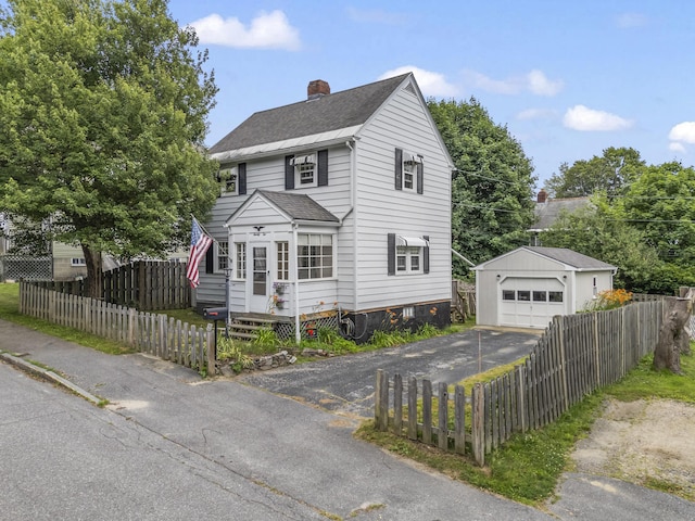 22 Cobb Rd, Bath, ME 04530 - view of front facade with an outdoor structure, a chimney, a detached garage, a shingled roof, and a fenced front yard