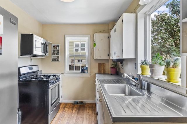 22 Cobb Rd, Bath, ME 04530 - kitchen featuring stainless steel counters, stainless steel appliances, hardwood / wood-style flooring, and white cabinets
