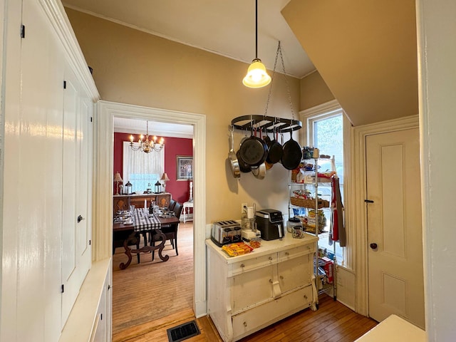 81 Parkview Ave, Bangor, ME 04401 - hallway with light wood-type flooring and a chandelier