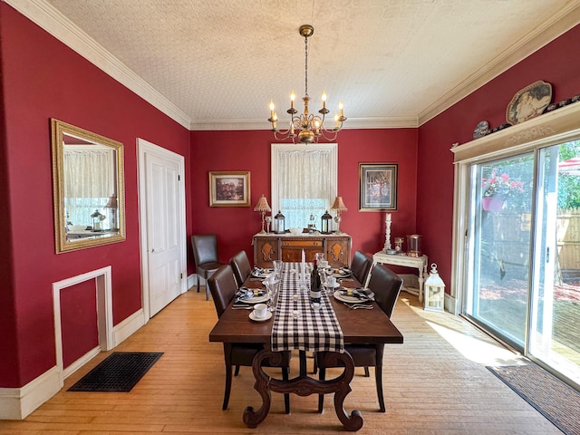81 Parkview Ave, Bangor, ME 04401 - dining area with a chandelier, light wood-type flooring, and crown molding