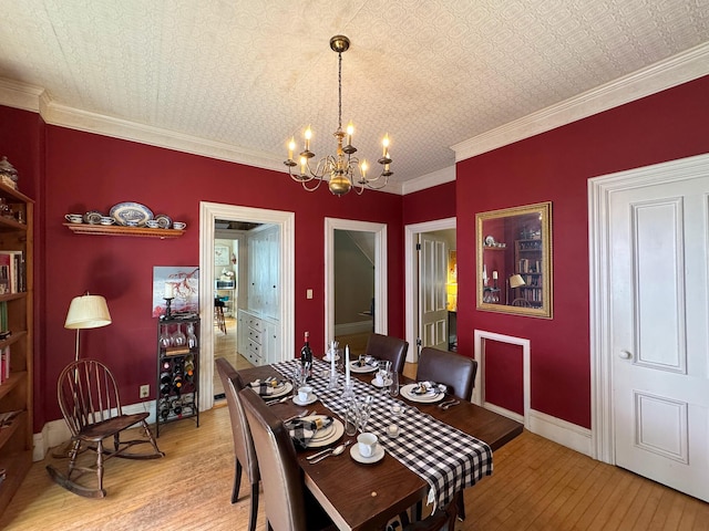 81 Parkview Ave, Bangor, ME 04401 - dining room featuring light wood finished floors, a chandelier, an ornate ceiling, and ornamental molding