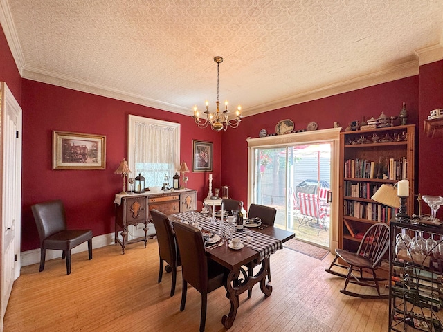 81 Parkview Ave, Bangor, ME 04401 - dining space with a chandelier, light wood finished floors, plenty of natural light, and crown molding