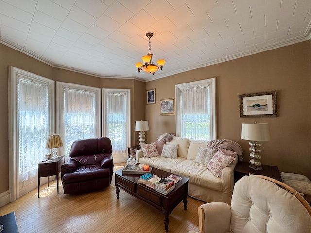 81 Parkview Ave, Bangor, ME 04401 - living area with crown molding, light wood-style floors, and a chandelier