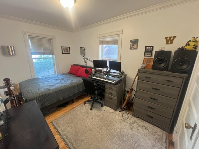 78 Mellen St Unit 2, Portland, ME 04101 - bedroom featuring ornamental molding, light wood finished floors, and a desk