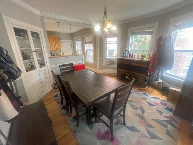 78 Mellen St Unit 2, Portland, ME 04101 - dining space with ornamental molding, light wood-style floors, and a chandelier