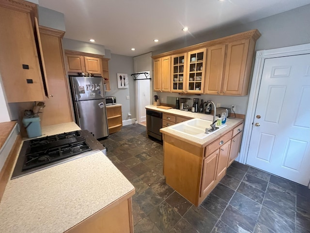 78 Mellen St Unit 2, Portland, ME 04101 - kitchen with appliances with stainless steel finishes, a peninsula, glass insert cabinets, light countertops, and dark stone finish flooring