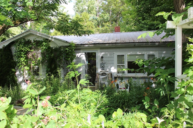 7 Maple St, Milbridge, ME 04658 - view of front of house with a metal roof and a chimney