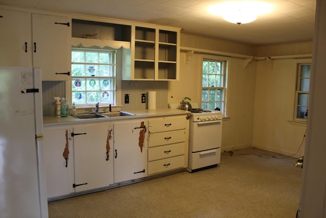 7 Maple St, Milbridge, ME 04658 - kitchen featuring white appliances, white cabinetry, light countertops, and light carpet