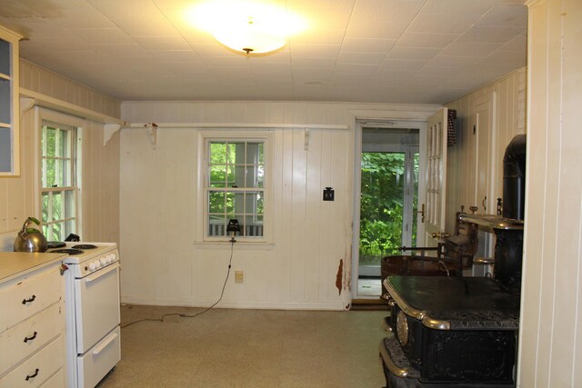 7 Maple St, Milbridge, ME 04658 - kitchen featuring white electric range, healthy amount of natural light, light floors, and wooden walls